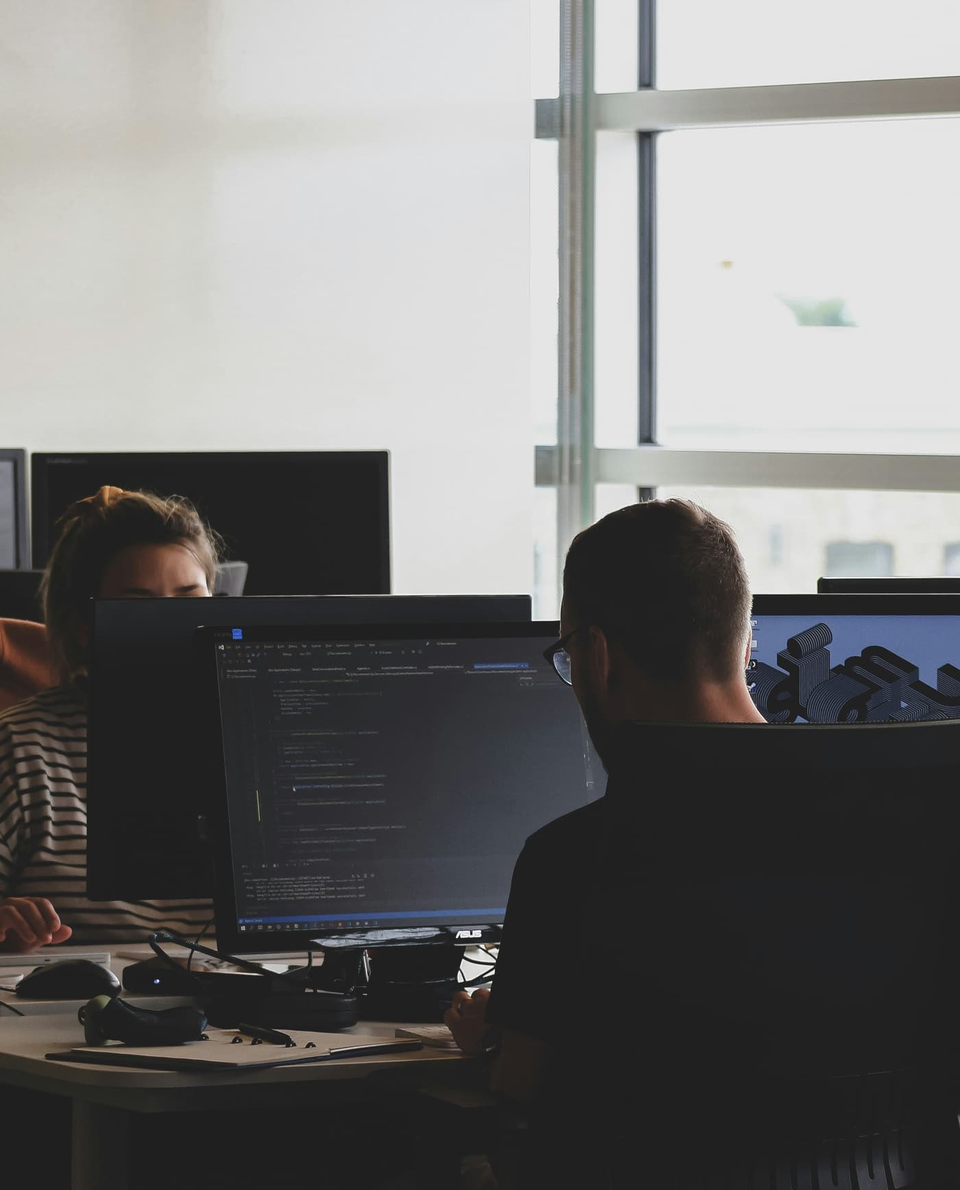 A team of engineers working at their desks in a bright, modern office